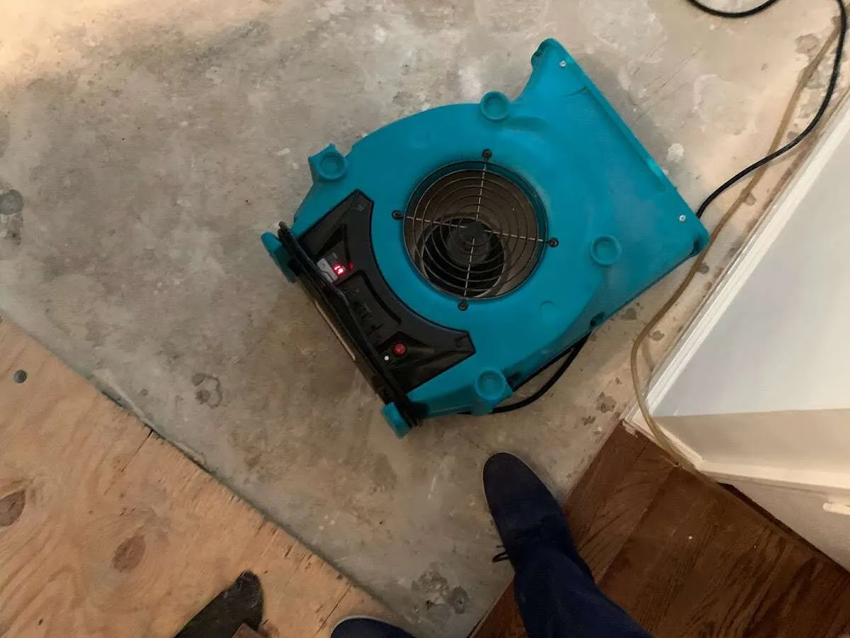 Air mover drying subfloor during Commercial Water Damage Restoration in Lowes Island